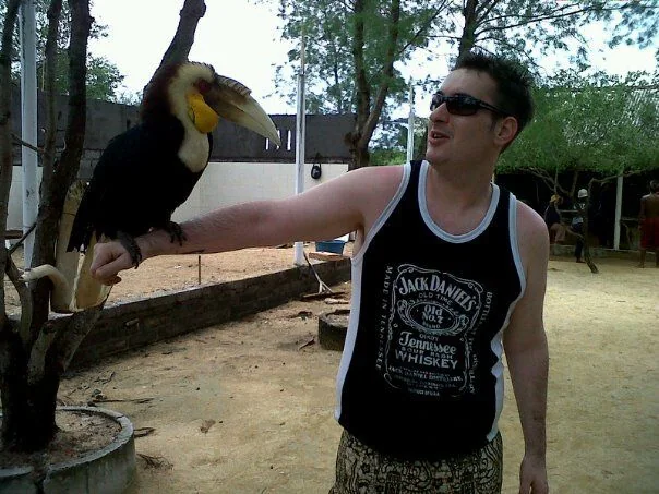 Shafaet with a bird perched on his arm